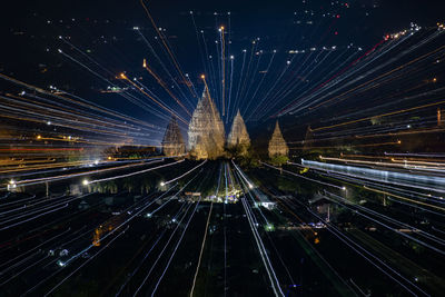 High angle view of illuminated railroad tracks in city at night