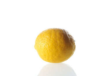 Close-up of fruit over white background