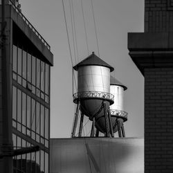 Low angle view of water towers against sky