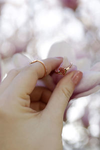 Cropped hand of woman holding engagement ring