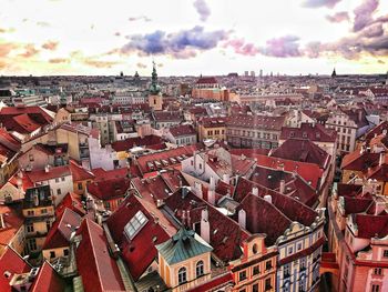 Townscape against cloudy sky during sunset