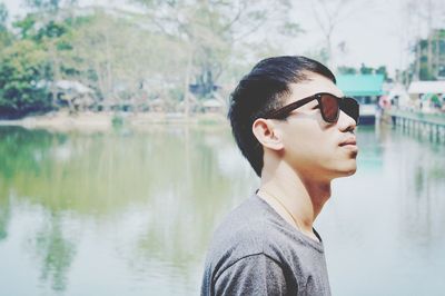 Woman in sunglasses against lake