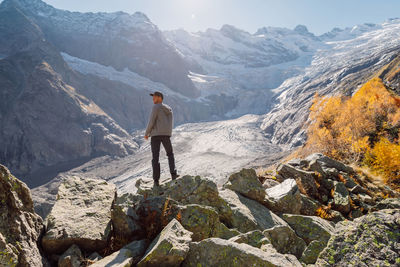 Rear view of man walking on mountain