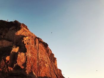 Low angle view of rock formation against sky