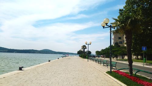 Street by sea against sky