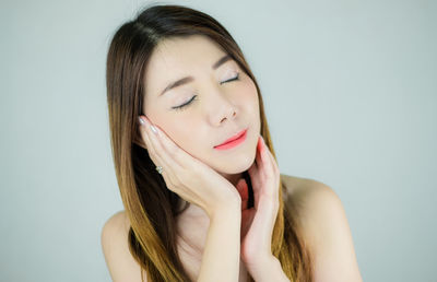 Portrait of a beautiful young woman over white background