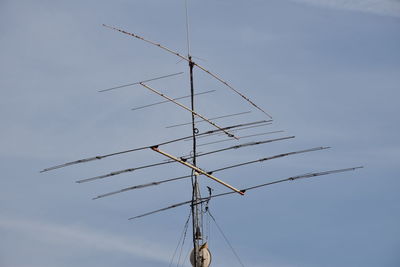 Low angle view of telephone pole against sky