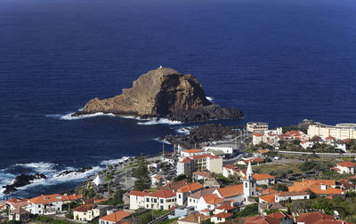 High angle view of houses by seascape