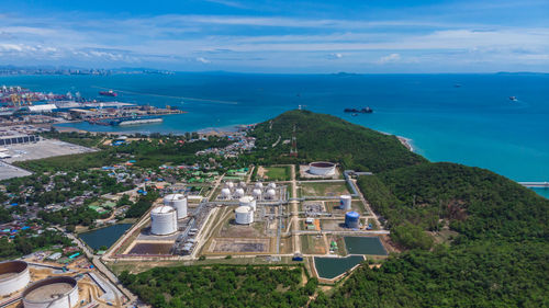 High angle view of refinery buildings area and mountain sea blue sky backgrounds 