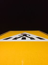 Close-up of yellow car on black background