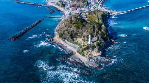 High angle view of lighthouse by sea