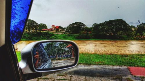 Reflection of trees in water against sky
