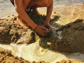 High angle view of woman on rock at beach