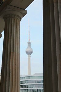 View of communications tower and buildings in city