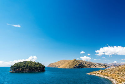 Panoramic view of landscape against blue sky