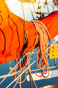 Low angle view of cables against orange sky