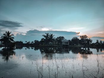 Scenic view of lake against sky during sunset