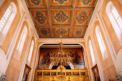 Low angle view of illuminated chandelier in building