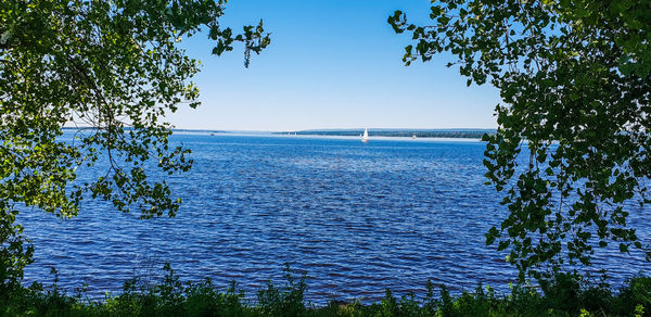 Scenic view of sea against clear blue sky