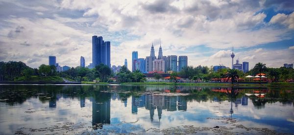 Panoramic view of lake and buildings against sky