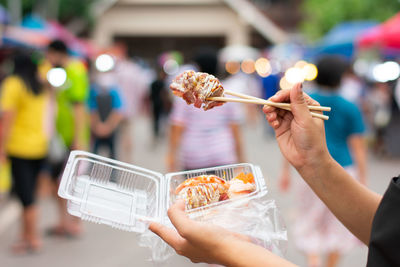 Midsection of people holding ice cream