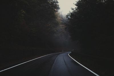 Road amidst trees against sky