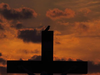 Low angle view of silhouette bird against sky at sunset