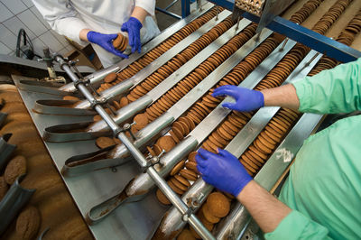 Cropped hand of man working in factory