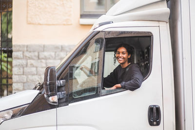 Portrait of smiling woman in car