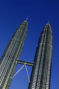 Low angle view of petronas towers in city against sky