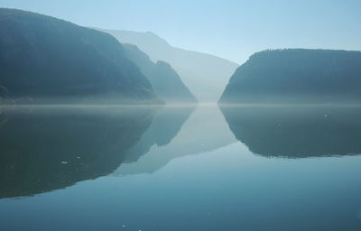 Scenic view of lake and mountains against clear sky