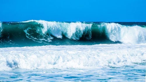 Scenic view of sea against clear blue sky