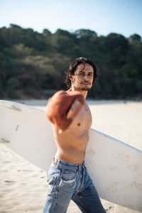 Portrait of young man standing on beach