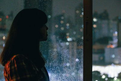 Woman looking at view through window