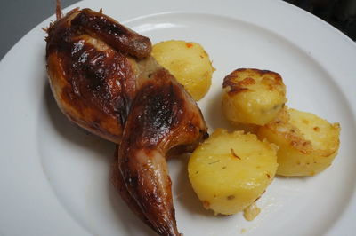 High angle view of chicken and potatoes served in plate