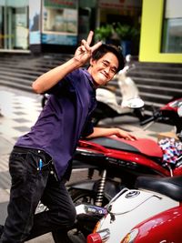 Portrait of smiling man sitting on car