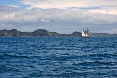 Sailboat sailing on sea against sky