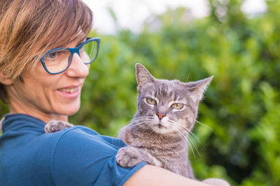 Portrait of smiling woman sitting outdoors