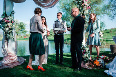 Group of people standing by plants