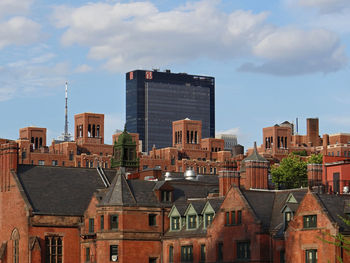 View of cityscape against cloudy sky