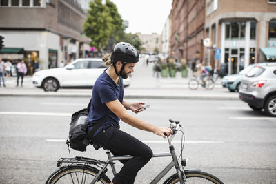 Man riding bicycle on city street