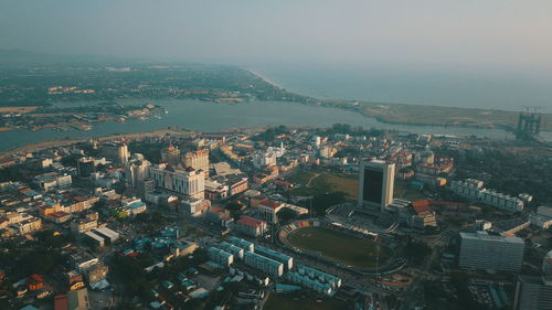 High angle view of buildings in town against sky