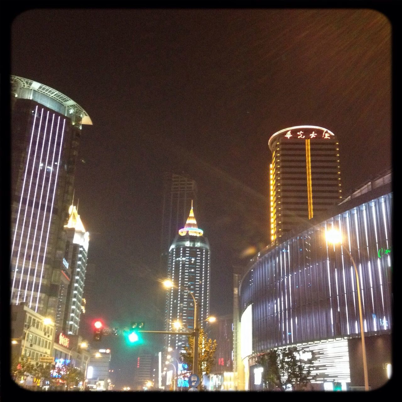 architecture, built structure, building exterior, city, skyscraper, modern, tall - high, tower, illuminated, office building, capital cities, night, transfer print, low angle view, famous place, travel destinations, auto post production filter, financial district, reflection, city life