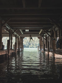 Interior of pier over sea against building