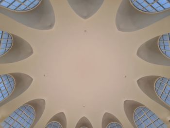 Low section of man standing on ceiling of building