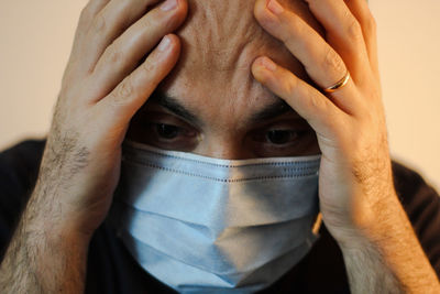 Close-up portrait of man covering face