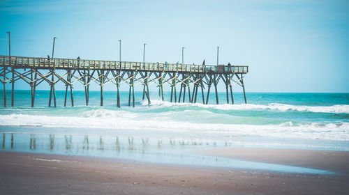 Pier over sea against sky