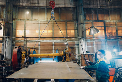 Rear view of man working at workshop