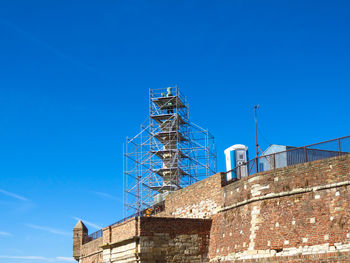 Low angle view of building against clear blue sky