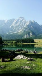 Scenic view of lake and mountains against clear sky